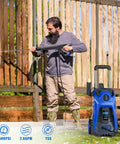 Man using Electric High Pressure Washer 3500 PSI 2.6 GPM with 25 ft hose and reel to clean a wooden fence outdoors.