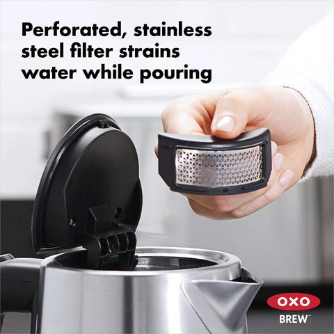 Person holding filter from Cordless Glass Electric Kettle With 1.75 Liter Capacity Borosilicate Glass For Pure Taste LED Power Indicator Auto Shutoff When Boiling Slow Release Lid For Steam Durable Quick Boil Easy Pour No Mess