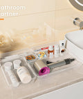 Clear Drawer Organizers Set Five Sizes Straight Up Tames Messy Vanities with cosmetics, hair tools, and accessories neatly sorted.