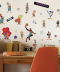 Space Jam LeBron Peel And Stick Giant Wall Decals Set on wall above desk, 21 characters and logos, sizes 2.13x2.17 to 12.48x35.58 inches.
