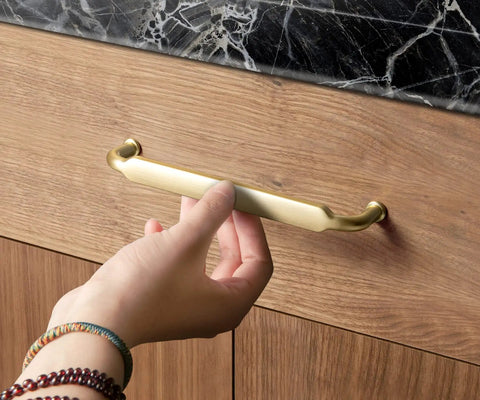 Hand holding Six Pack 10 Inch Hole Center Cabinet Pulls Light Brushed Brass Zinc Alloy Kitchen Drawer Handles 10.45 Inch Length