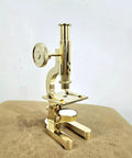 Top Shelf Handmade Solid Brass Microscope With Adjustable Focus Knob straight fire vintage desktop display on a leather surface.