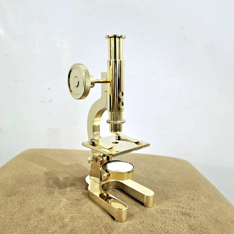 Top Shelf Handmade Solid Brass Microscope With Adjustable Focus Knob straight fire vintage desktop display on a leather surface.