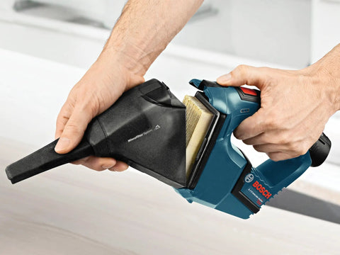 Hands using 12V Max Hand Vacuum Bare Tool For Quick Jobsite Cleanup With Ultra Lightweight Design, High Power Suction, Flat Filter Boosting Canister Capacity