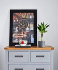 Gray dresser with matte black handles, featuring framed artwork and plant, showcasing set of 30 matte black square cabinet handles 3 3/4 inch center to center.