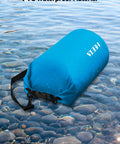 Waterproof Dry Bag Roll Top 5L Blue For Travel And Outdoor Adventures floating on water, showing PVC material and buckle.