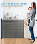 Woman using Extra Wide Retractable Baby Gate 33 Inch Tall Extends To 72 Inches Mesh Gate For Kids And Pets With Alarm in nursery.
