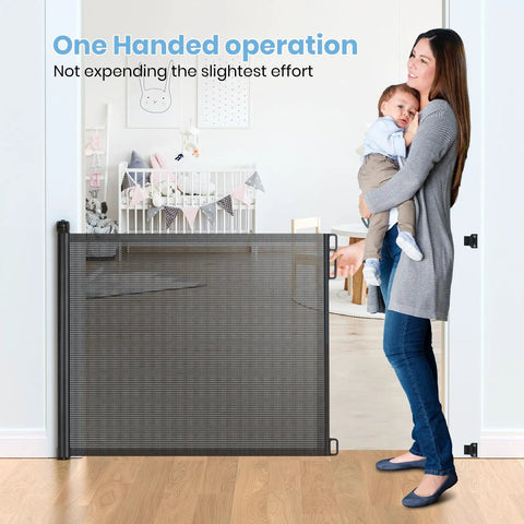 Woman using Extra Wide Retractable Baby Gate 33 Inch Tall Extends To 72 Inches Mesh Gate For Kids And Pets With Alarm in nursery.