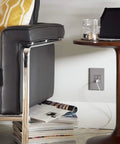 Living room with Adorne 1 Gang Wall Plate Magnesium Six Pack Screwless Snap In Design installed, shown near a table and chair.