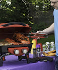 Man grilling lobsters using Stainless Steel 3 Piece BBQ Grilling Tool Set With Spatula Fork And Tongs Plus Bonus Grill Glove