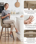Woman sitting on 26 Inch Counter Height Swivel Bar Stools Set Of 2 With Backs Linen Upholstery Solid Wood Legs, showing cushion detail.