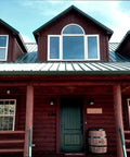 Top Shelf One Coat Wood Stain And Sealer For Thermally Modified Exterior Decking In Bold Black Canyon Red on log home exterior.