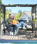 Couple relaxing on Three Seat Porch Swing With Stand And Cozy 990 LB Capacity 2 In 1 Convertible Bed And Swing Canopy in backyard