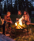 Group enjoying a 26 Inch Outdoor Wood Burning Fire Pit Heavy Duty Steel Bonfire Bowl With Spark Screen and Log Grate at night.