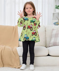 Ultra Soft Cotton Baby Girl Blouse With Ruffled Sleeves Featuring Farm Tractor Print On Green Background For Everyday, Holidays And School, Cozy Long Sleeve Top, Machine Washable, Easy Care 5T worn by a girl indoors.