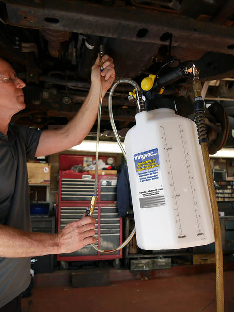 Person using ATF Sealed Fluid Extractor And Refill Kit For Auto Trans Fluids, 2.5 Gallon Capacity, 10 Liter, in a garage