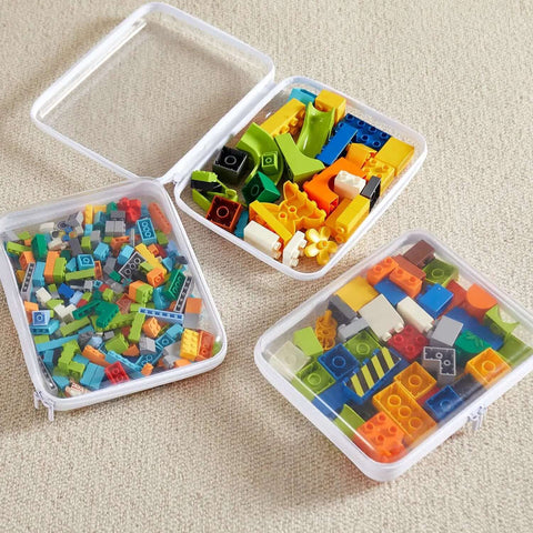 Hella Tough Four Piece Clear Hard Shell Case With Secure Zipper Closure, stacked cases filled with colorful Legos.