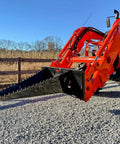 Stump Bucket For Tractors And Skid Steers Up To 105 HP With Bi Directional Ripping Edge attached to orange tractor, gravel path