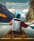 Person kayaking with Rugged All Weather Waterproof Hiking Backpack With Roll Top Closure Cushioned Dry Bag And Waterproof Phone Case Heavy Duty Pack For Kayaking Camping Fishing Biking And Everyday Use on back