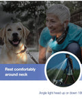 Woman walking dog at night wearing Bright Magnetic Neck Light 2 Pack With Detachable Lights For Hands Free Use, Black.