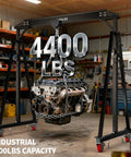 Heavy Duty Workhorse Gantry Crane 4400 Lbs Portable Garage Hoist with engine hanging in garage setting.