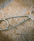 Close-up of hanging hook for Bombproof Stainless Steel Water Bottle With Hanging Hook For Outdoor Adventures on stone surface