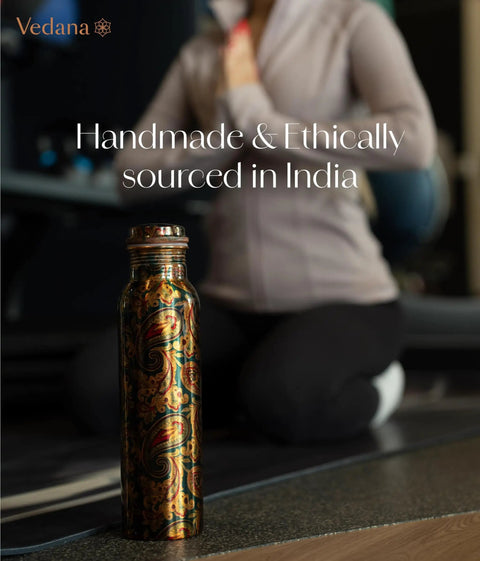 Copper Water Bottle 1 Liter With Ayurvedic Health Benefits beside person practicing yoga in gym
