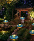 Solar Lotus Flower Garden Lights For Outdoor Patio Decor, glowing crackle balls in lush garden setting at night, gradient blue finish.