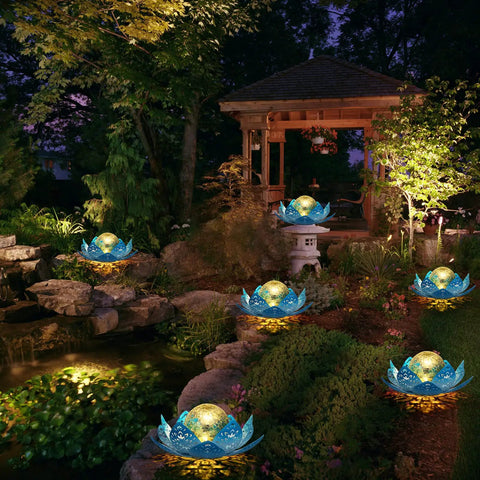 Solar Lotus Flower Garden Lights For Outdoor Patio Decor, glowing crackle balls in lush garden setting at night, gradient blue finish.
