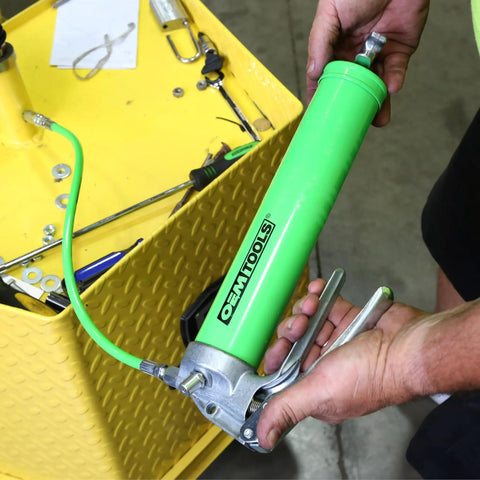 Man using Beefy Pistol Grip Grease Gun Kit With 18 Inch Hose And Coupler Flexible Hose For Auto And Shop Use 6000 PSI High Pressure Durable Cast Aluminum Pump Head Grease Gun For Cartridge Or Bulk Fill