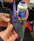 Permatex Ceramic Extreme Brake Parts Lubricant, 8 oz bottle, applied to a brake pad (close-up view)