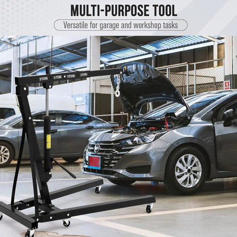 Heavy Hitter Foldable Hydraulic Engine Hoist Cherry Picker 4400 Lbs Capacity for use in garage with car hood raised.