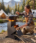 Woman cooking on Rocket Stove For Camping And Outdoor Cooking Portable Wood Burning Stove With Storage Bag 15 Inch High Efficiency Outdoor Stove For Backyard BBQs Picnics And Events Heavy Duty 8.8 Lb