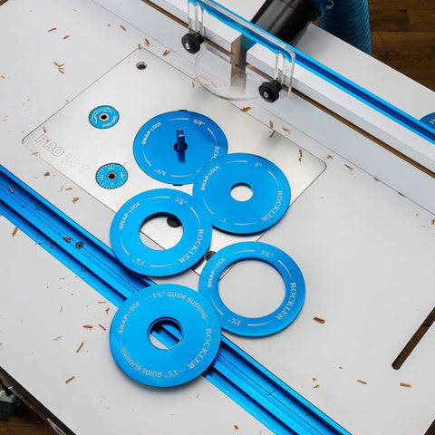 Locking Router Plate Insert Kit With Twist Locks For Router Table Insert Plate Aluminum Construction Fits Properly And Controls Dust No Tools Needed To Install 5 Pack Ideal For Woodworking And Dust Free Routing displayed on a router table with blue rings.