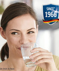 Woman enjoying fresh water from a glass, highlighting No Worries Water Filter Replacement Cartridges Pack Of Four For Pitchers And Coffee Pots.