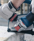 Street Tough 4.5 Inch Angle Grinder Featuring X Lock Tool Free Disc Swap Mount in use on concrete surface, ergonomic grip visible.