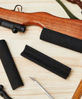 Black EVA pads shown on wooden rifle, part of 12 Pack Rifle Cheek Riser Pads Dope Non Slip EVA Foam 3 Height Levels For Buttstock Cover
