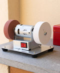 Badass Household Bench Grinder And Electric Sharpening Tool For Metal Tools Shears And Kitchen Knives Easy Rust Removal With Mirror Polish Finish on countertop.