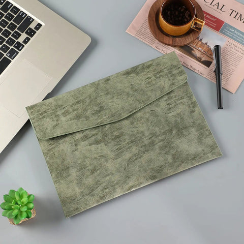 PU Leather A4 File Folder Waterproof Document Holder With Snap Closure Army Green on desk with laptop and newspaper