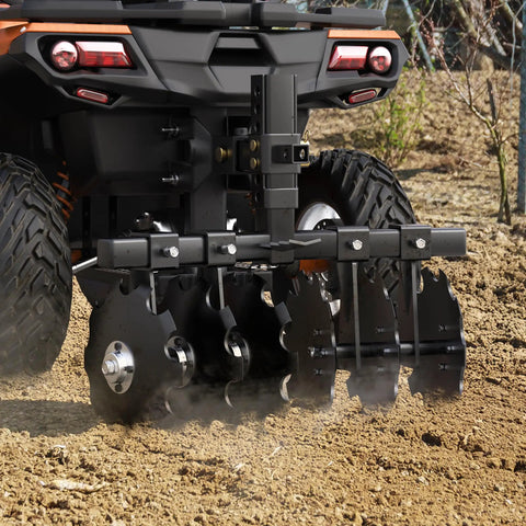 28-Inch Heavy-Duty Disc Plow Harrow With Universal 2-Inch Receiver attached to ATV, black steel, used for soil preparation.