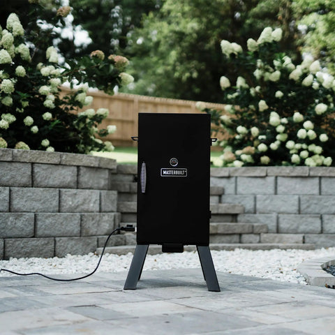 Electric Vertical BBQ Smoker With Analog Temperature Control 30 Inch Black Unit Featuring 535 Sq In Of Cooking Space Chrome Smoking Racks Removable Wood Chip Tray Perfect For Up To 3 Chickens Or 2 Turkeys Or 3 Racks Of Ribs on a patio
