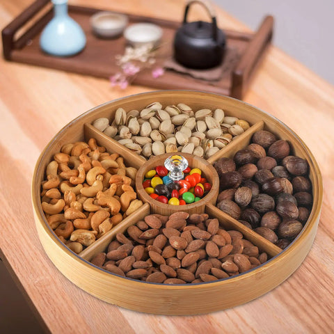 Top Grade Bamboo Serving Platter With Built-In Dividers, 12 Inch Snack Board For Fresh Fruit And Nuts filled with assorted nuts and candies.