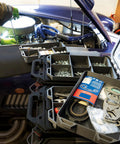 Quad FlexiTray Flexible Tool Tray System For Milwaukee PACKOUT Compatible Organizer in use on car engine, workshop setting.