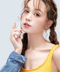 Woman holding 2 Pack 1Oz Clear Plastic Travel Spray Bottles Refillable Mini Spritzers For Travel Cleaning Gardening Skin Care Essential Oils And Perfume With Protective Caps Leak Free On The Go