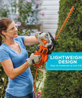 Person using Powerful 3.0 Amp Electric Hedge Trimmer With 16 Inch Blade Lightweight Compact Corded Yard Tool on bush