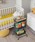 Three Tier Rolling Utility Cart With Cover Top And Wheels For Office Kitchen Bathroom On The Go Storage Cart Includes Three Baskets Six Hooks Three Cups And A Lid Top For Laptop Coffee Crafts And More Black beside a crib.