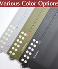 Hella Spacious Magnetic Gun Cleaning Mat Fifty Point Two Inches Long Built Tough Oil Resistant Floor Pad With Tool Slots For All Long Guns And Handguns in grey, green, and black colors.