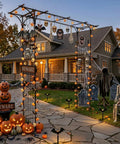 Sturdy Steel Garden Archway For Weddings And Yard Vibes, decorated with Halloween props, pumpkins, and spooky figures, in front of a house.