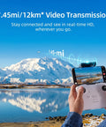 Person holding controller for Top Of The Line Mini Drone With Camera Cranking 4K 60fps Smooth Videos And 8K Ultra-Clear Photos Plus Includes 256GB Micro SD Card And Extra Batteries For Insane Flight Time On Your Next Epic Adventure against scenic mountain backdrop.