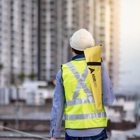 Person carrying Mini Stakeout Prism Pole Made From Aluminum For High Accuracy Surveying On Site with yellow case